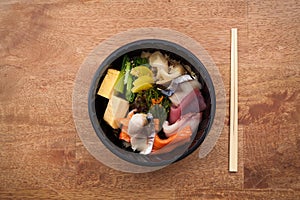 Japanese food Tekka Don take away on wooden background