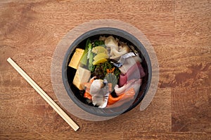 Japanese food Tekka Don take away on wooden background