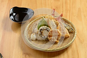 japanese food Tempura Moriawase in a wooden plate isolated on wooden table top view