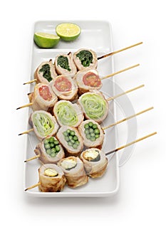 Japanese food. Vegetables wrapped in thinly sliced pork meat are skewered and grilled. There are five types of vegetables: young c