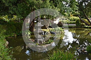 Japanese garden with pond and lanterns in Ueno, Tokyo, Japan