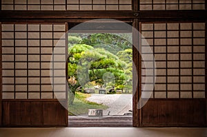 Japanese garden seen through sliding door.