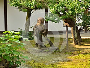 Japanese garden and sweeping statue, Kyoto Japan