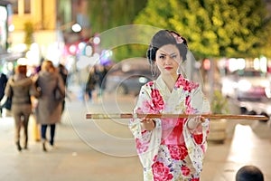 Japanese geisha samurai with sword outside at night