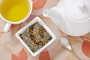 Japanese genmaicha, a mix green tea with roasted rice, cup of tea and teapot photo