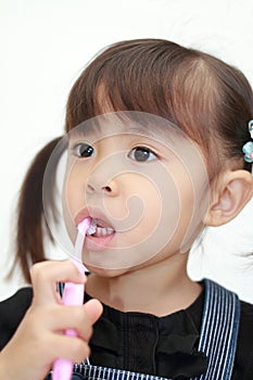 Japanese girl brushing her teeth