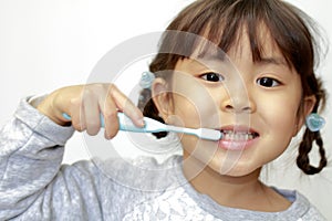 Japanese girl brushing her teeth