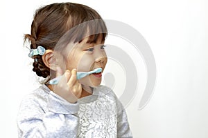 Japanese girl brushing her teeth