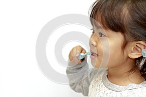 Japanese girl brushing her teeth