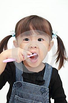 Japanese girl brushing her teeth