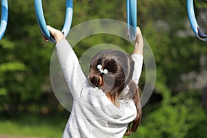 Japanese girl playing with a monkey bars