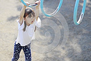 Japanese girl playing with a monkey bars