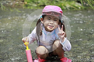 Japanese girl playing in the river