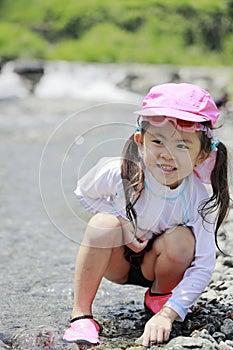 Japanese girl playing in the river