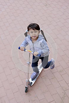 Japanese girl riding on a scooter