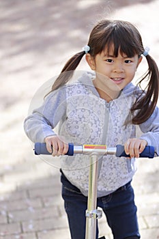 Japanese girl riding on a scooter