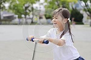 Japanese girl riding on a scooter