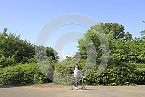 Japanese girl riding on a scooter