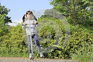 Japanese girl riding on a scooter