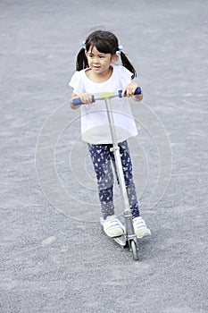 Japanese girl riding on a scooter