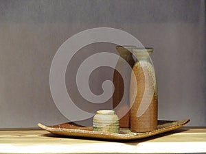 Japanese green and brown sake ceramic sets on square tray with shadow