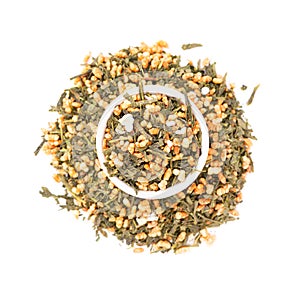 Japanese green tea Genmaicha, isolated on white background. Tea leaves with roasted brown rice. Organic tea. Top view. Close up