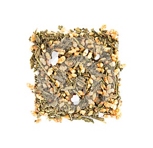 Japanese green tea Genmaicha, isolated on white background. Tea leaves with roasted brown rice. Organic tea. Top view. Close up