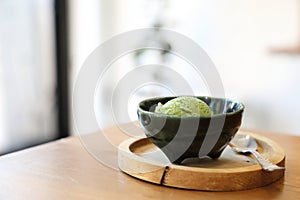 Japanese green tea ice cream with red bean topping on wooden tray in coffee shop