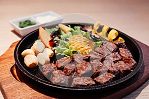 Japanese grilled beef steak Gyu Teppanyaki on hot plate with sal