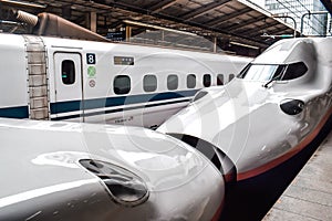 Japanese high speed Shinkansen bullet train standing on a platform in Tokyo station