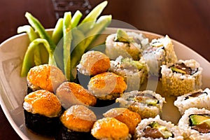 Japanese hot sushi and rolls with salmon, avocado, cucumber and