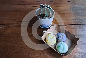 Japanese ice cream Mochi on a brown-paper plate on a wooden table