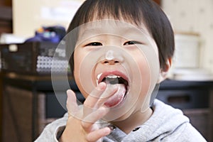 Japanese infant eating a pinch