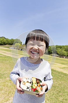 Japanese infant who is delighted with bento,