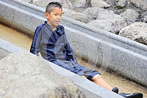 Japanese junior high school student playing in the river with water slide