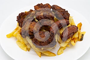 Japanese Karaage Fried Chicken with Fries and Sausage on a White Plate