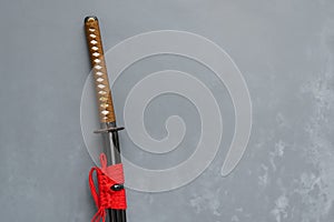 Japanese katana sword with loft Concrete background.