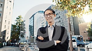 Japanese lawyer man, portrait and city with arms crossed, pride and smile for job at legal agency. Person, attorney or