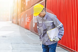 Japanese male smart worker working in container port cargo. Japan shipping logistics industry customs staff