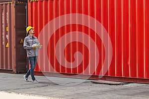 Japanese male smart worker working in container port cargo. Japan shipping logistics industry customs staff