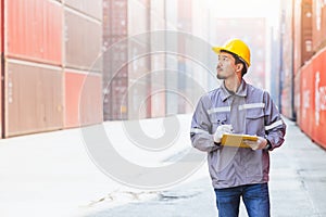 Japanese male smart worker working in container port cargo. Japan shipping logistics industry customs staff