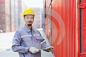 Japanese male smart worker working in container port cargo. Japan shipping logistics industry customs staff