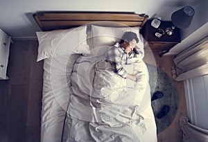 Japanese man sleeping on bed