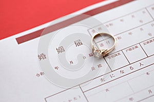 Japanese marriage registration blank document and wedding proposition ring on table