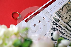 Japanese marriage registration blank document and wedding proposition ring and yen money on table