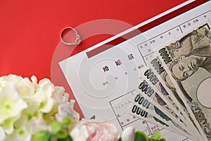 Japanese marriage registration blank document and wedding proposition ring and yen money on table