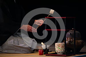 Japanese master in traditional kimono, during the tea ceremony