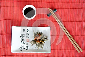 Japanese meals on red mat with sticks