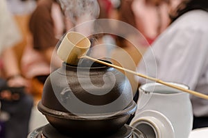 Japanese men preparing green tea during a demonstration.  Japanese tea ceremony