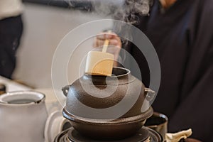 Japanese men preparing green tea during a demonstration.  Japanese tea ceremony